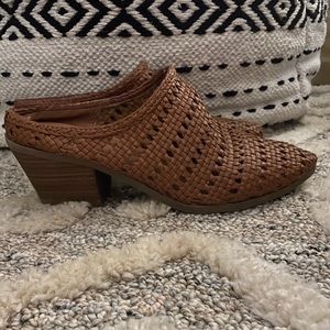 Tan woven mules.